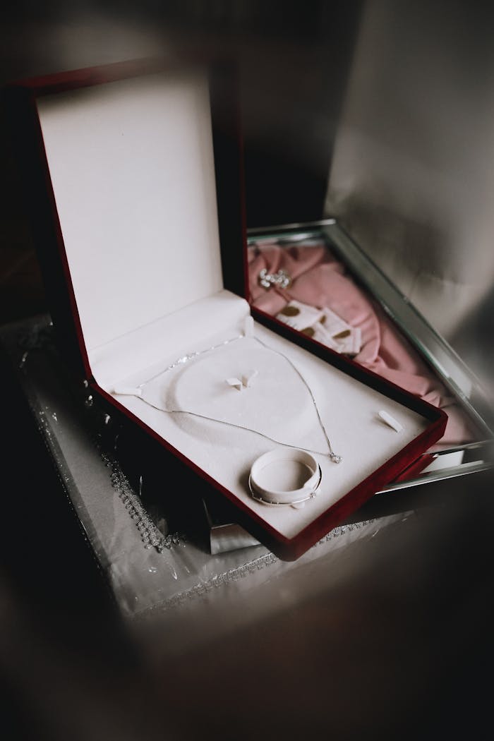 Beautiful silver necklace and bracelet in a luxurious open jewelry box, perfect for gifts.